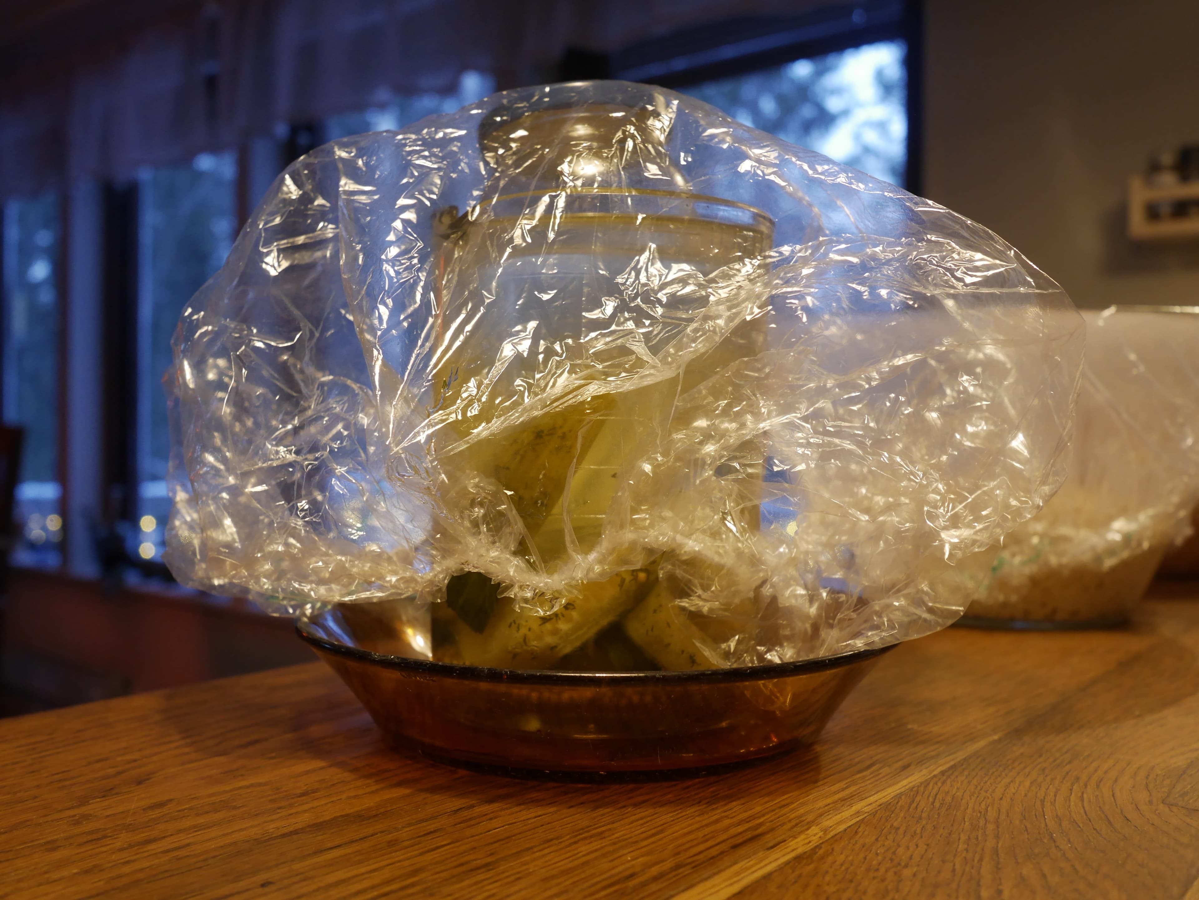 A jar of water being used as a fermenting weight.