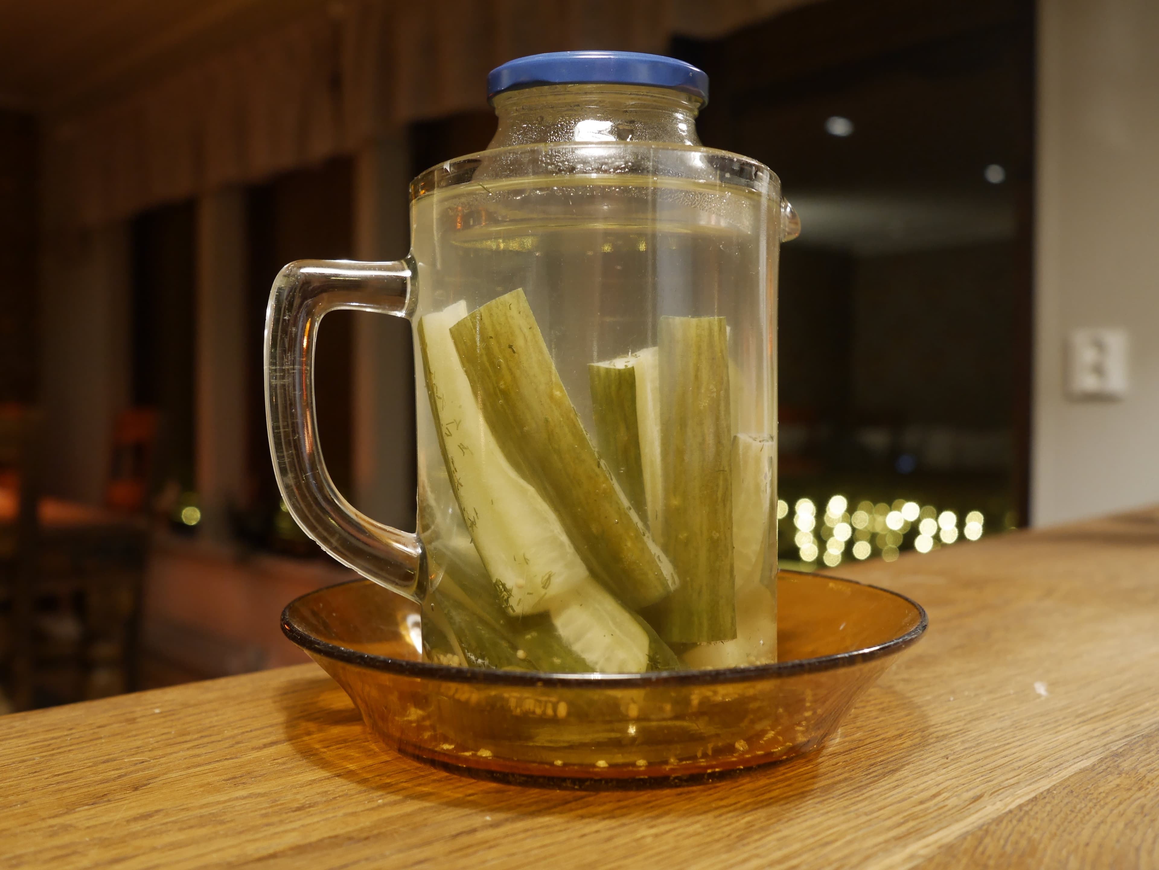 A jar of water being used as a fermenting weight.